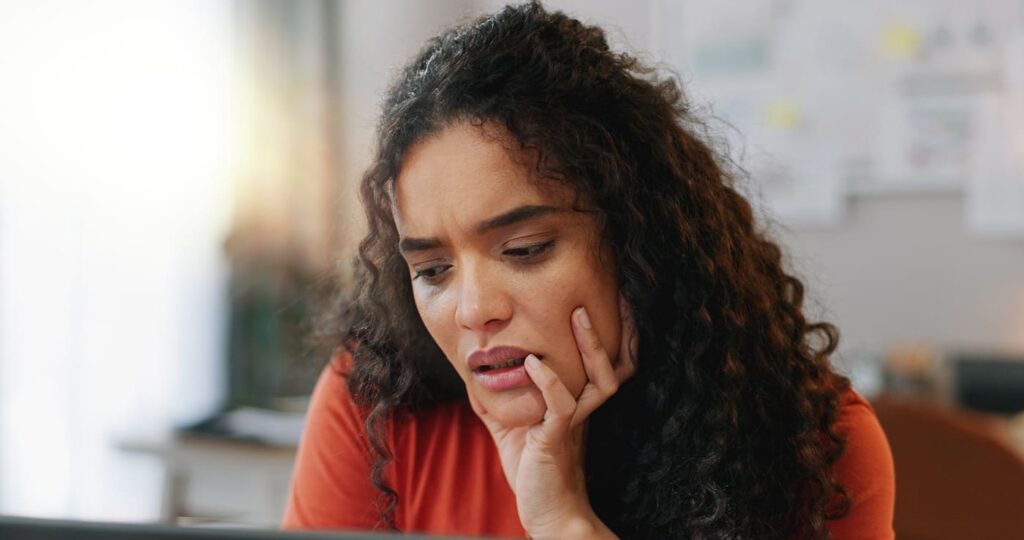 Woman with ADHD and anxiety stressed at work, facing challenges.